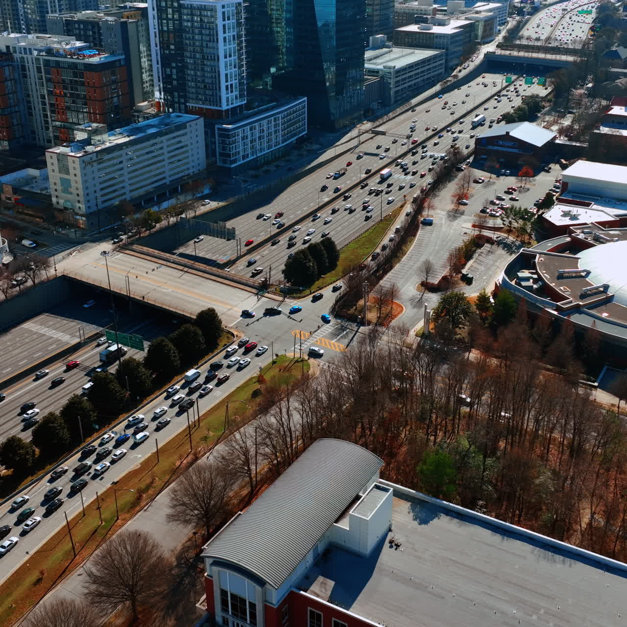 Drone flying above the busy highway in Atlanta downtown. View on the traffic in metropolis on sunny day.