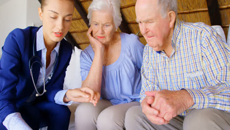 front view of caucasian female doctor discussing medication with senior couple at comfortable home 4