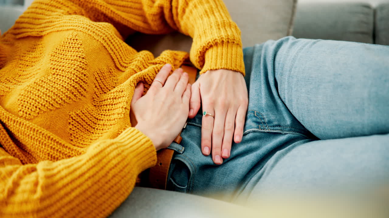 Woman in yellow sweater and jeans on couch