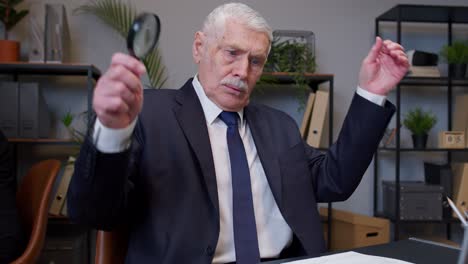 elderly old businessman checking paperwork correspondence at office, shocked surprised, disbelief