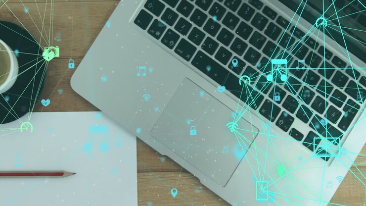 Animation of globes of digital icons over close up of a laptop and coffee cup on wooden surface