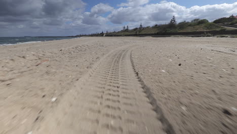 Tyre--tire-track-in-sand-on-Hampton-Bay-beach,-sunny-day-time