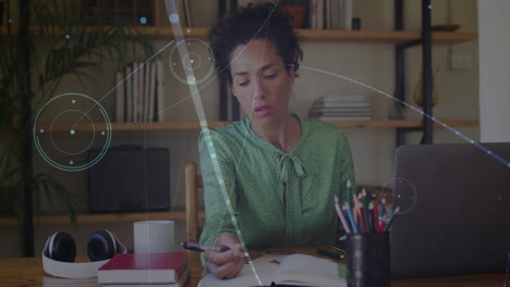 woman writing in home office, with floating technology data charts and laptop analytics animations