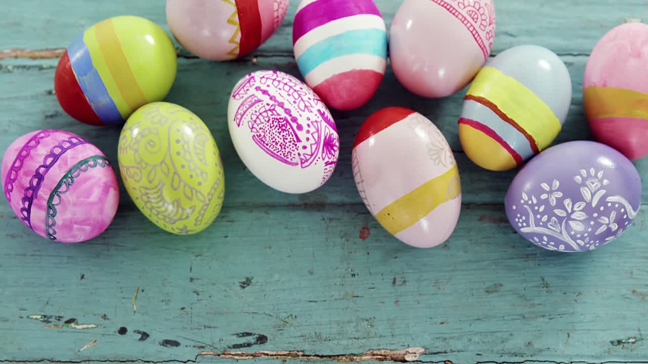 Painted Easter eggs on wooden surface