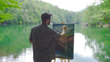 Painter-painting-against-the-lake.