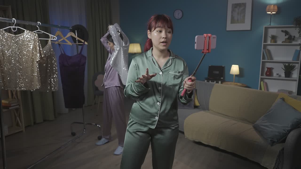 Two Women in Pajamas Recording a Fashion Video