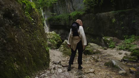 woman hiking in a mountain canyon