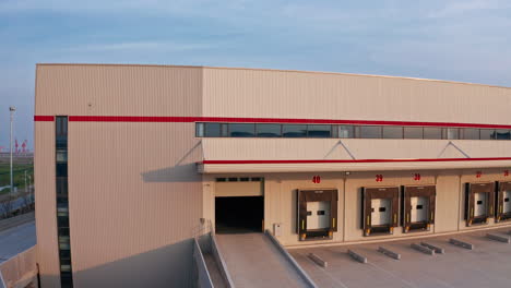 amazing drone shot flying out of warehouse showing interior and exterior