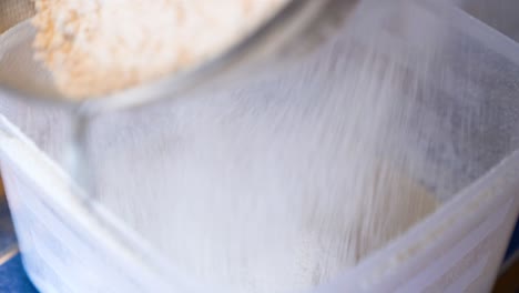 Bag-Being-Filled-With-Freshly-Milled-Wheat-Flour-Through-Sifter