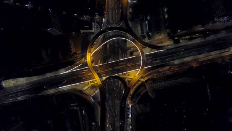 night time illuminated guangzhou city famous round traffic road junction aerial top view 4k china