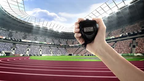 hand holding stopwatch in olympic stadium