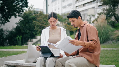 Amigos-Inteligentes-Estudiando-Tableta-En-Un-Banco-Del-Parque.-Estudiantes-Universitarios-Revisando-Papeles