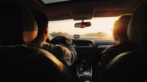 A-Young-Couple-Travels-In-A-Car-A-View-From-Behind