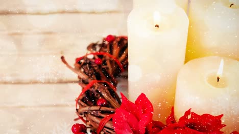 candles and christmas decoration combined with falling snow