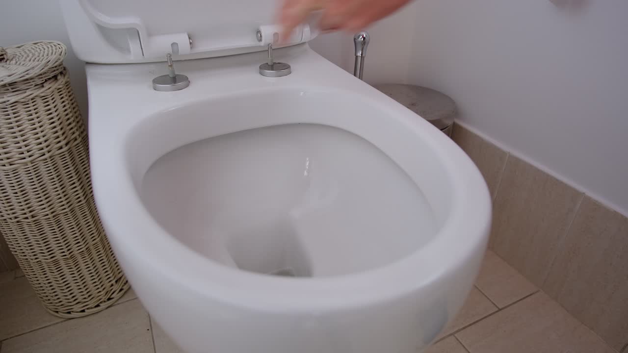 Cleaning white toilet bowl ready for next guests