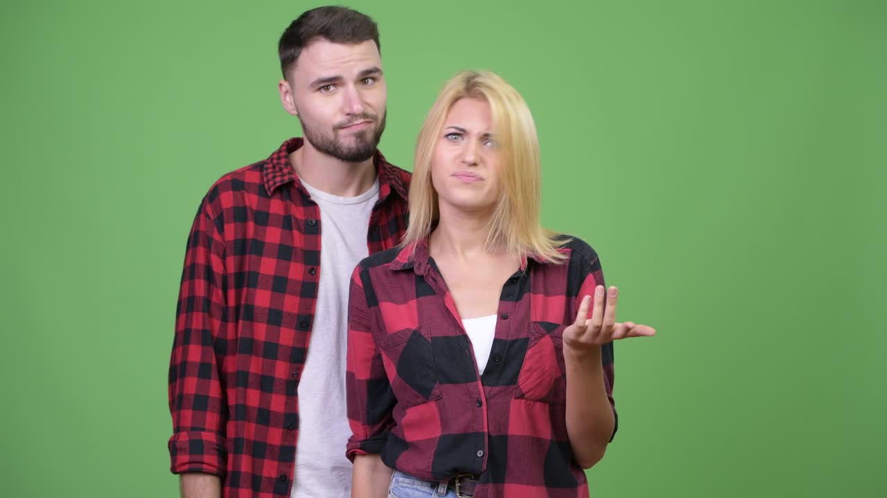 Young woman being angry together with young man