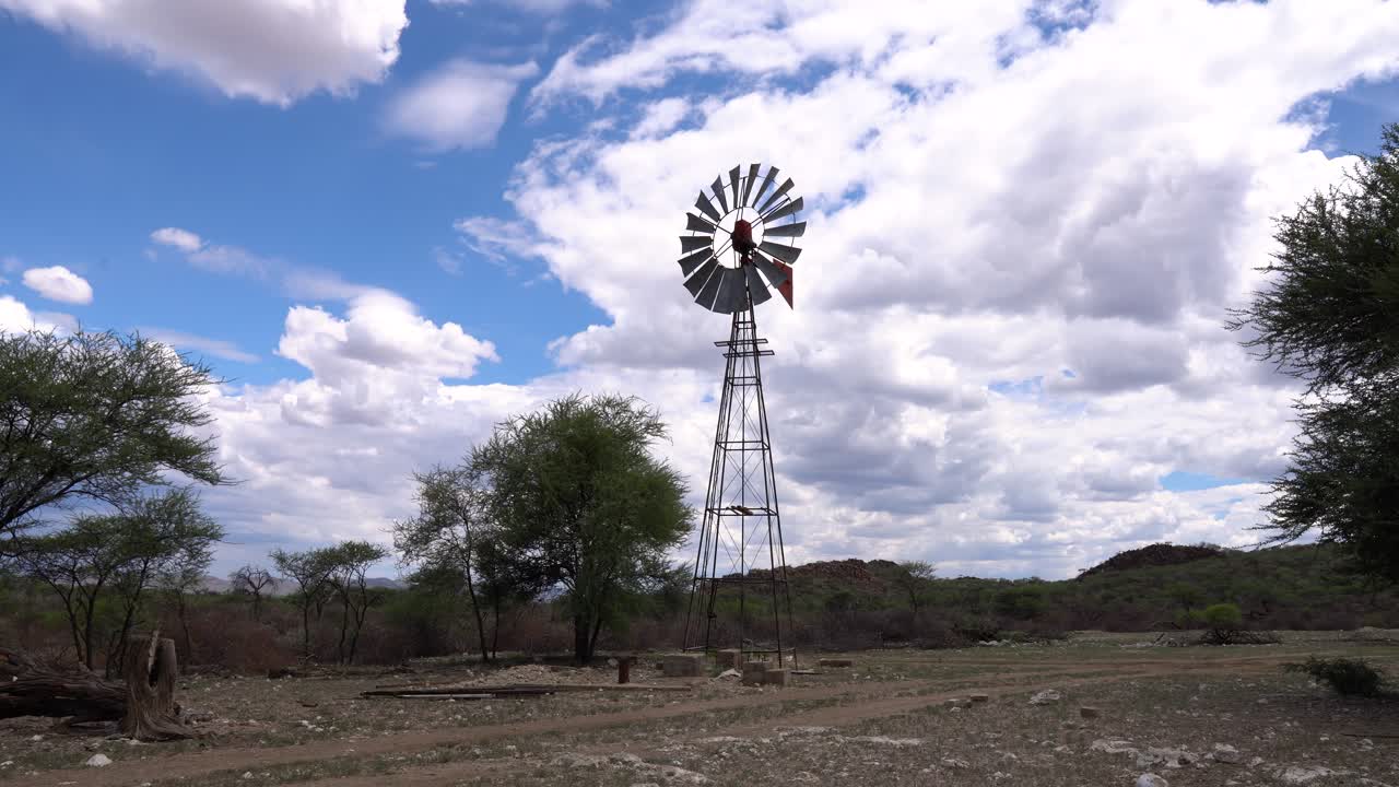 tiro todavía estable de una bomba de viento que sopla en el viento en una granja en namibia en un día nublado y soleado
