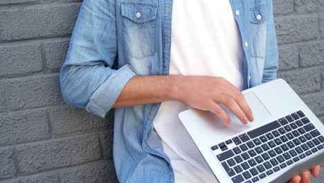 fashionable man using laptop