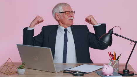 senior office businessman showing biceps, looking confident, feeling power strength to success win