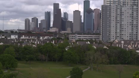 crane shot revealing downtown houston from bayou park