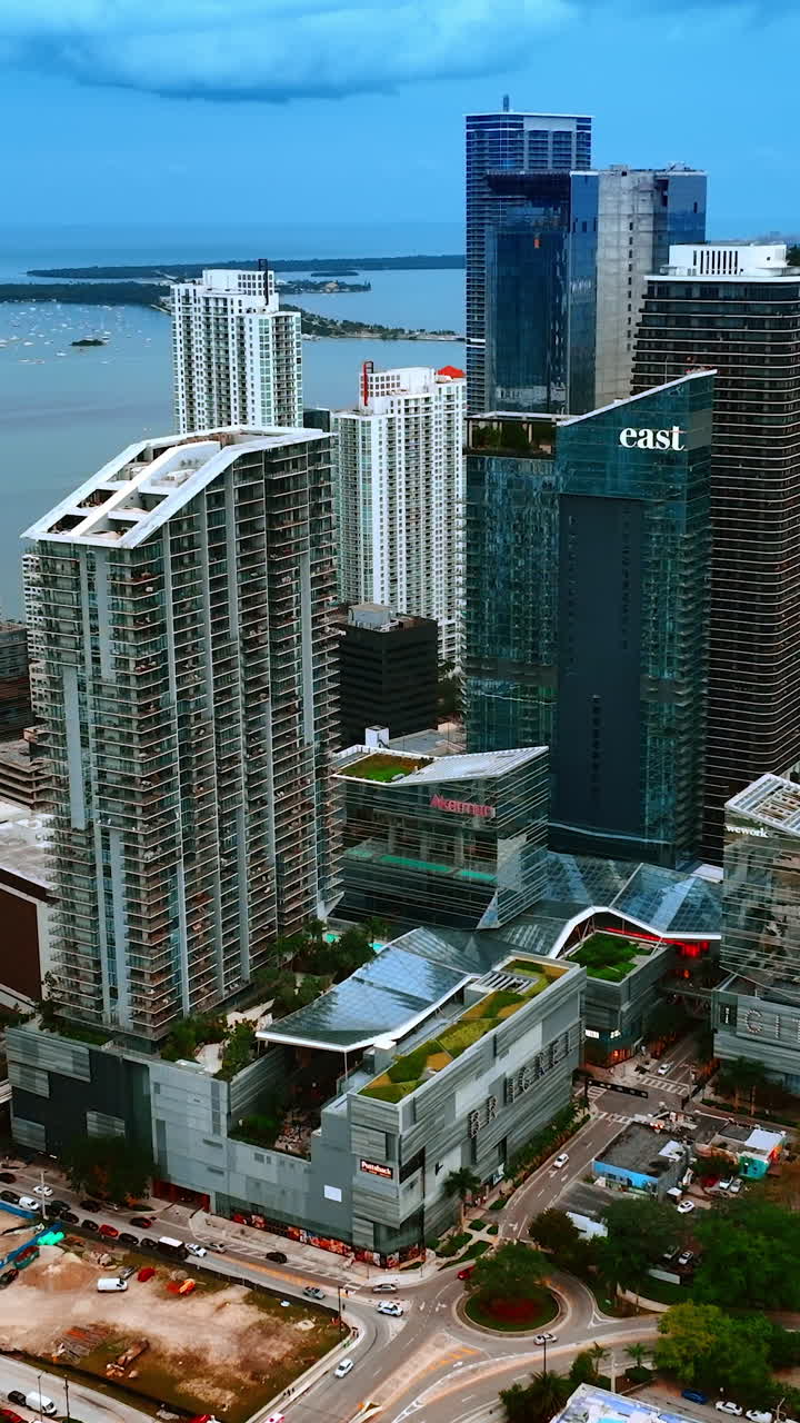 A group of multi-storied blocks of flats in the residential area of Miami, Florida, USA. Waterscape and Miami Beach at backdrop. Vertical video