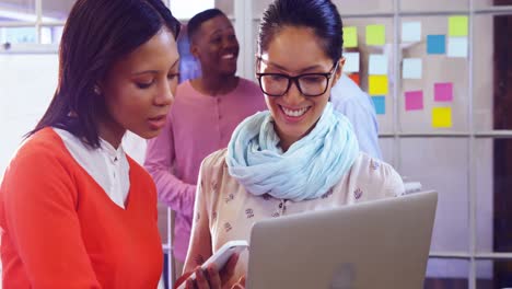 Female-business-executive-discussing-over-digital-tablet