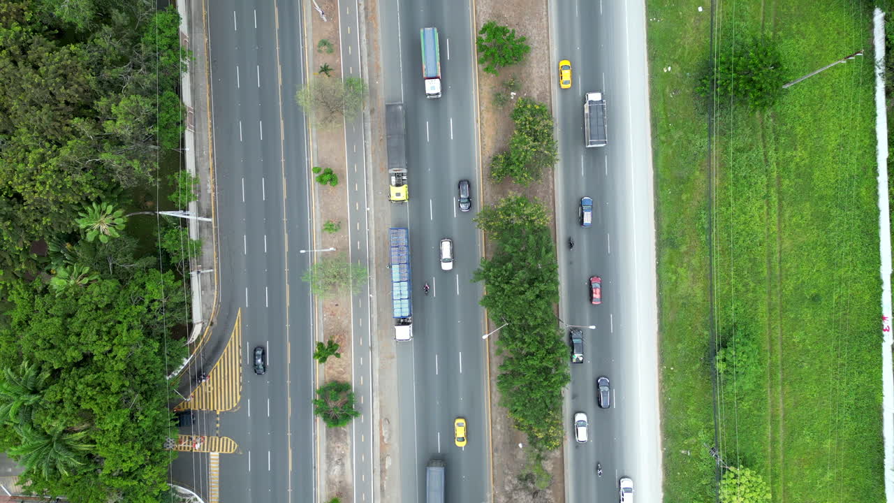 Aerial footage of Via a la Costa, Ecuador. Showcases the highway, residential areas, and lush landscapes. Perfect for travel, real estate, and urban planning visuals.