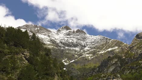 clouds forming over snowy mountain, dramatic nature time lapse, pyrenees landscape