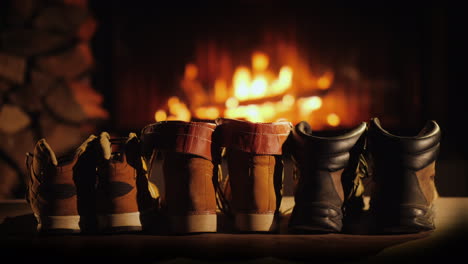 wet winter shoes are dried by the fireplace rest after a winter walk and the comfort of a warm home