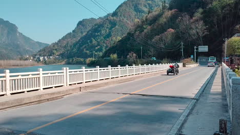 a side three wheeled motorcycle crosses the bridge