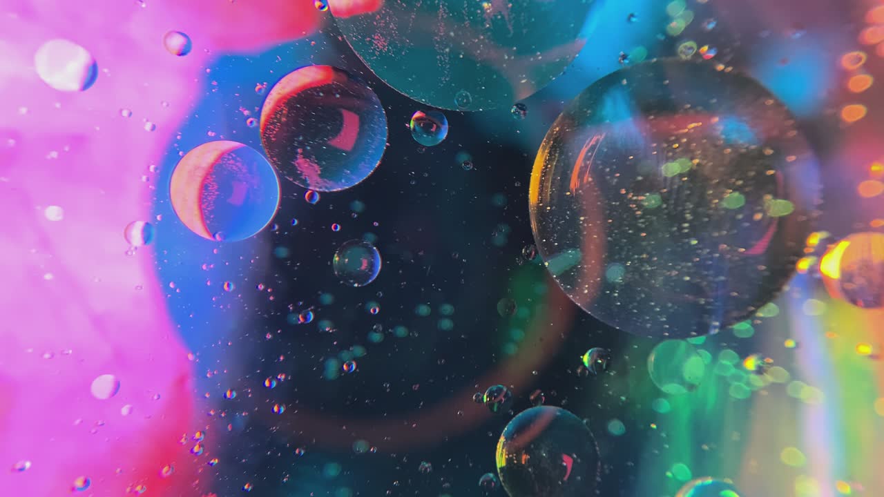 Close-up of oil bubbles in water.