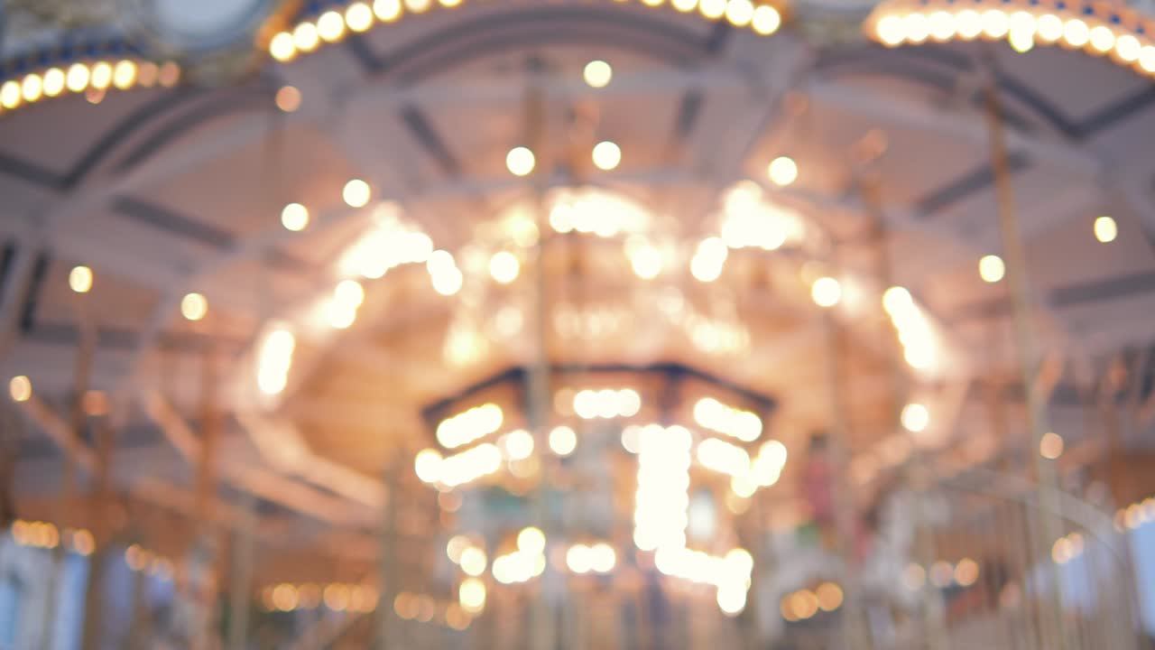 Blurred incredible colorful flashing light of carousel carnival fair merry go round circus horse ride at amusement park