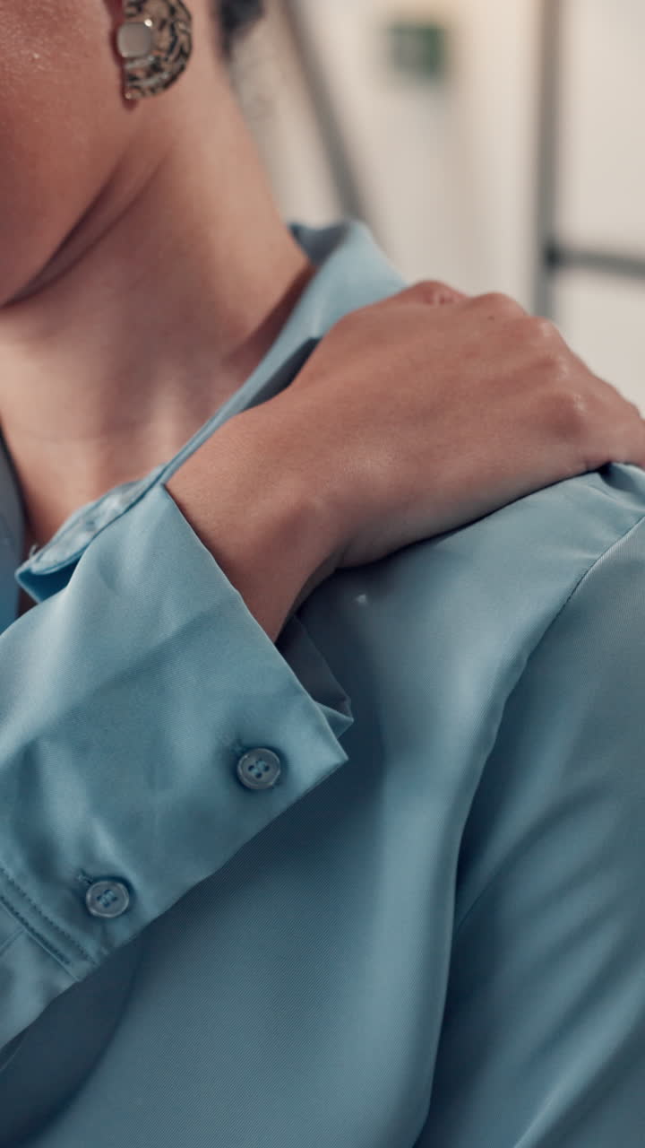 Close-up of a Person's Hand on Shoulder Wearing Blue Shirt