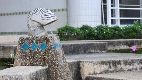 water streams through a fish sculpture over time