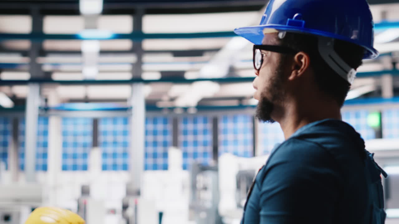 Vertical Video Black photovoltaics factory technician looking over paperwork documents