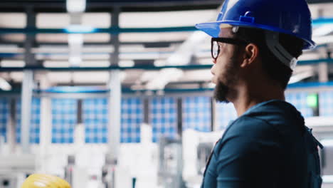 vertical video black photovoltaics factory technician looking over paperwork documents