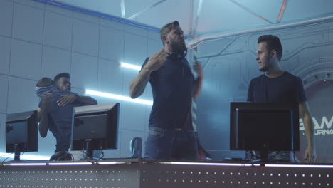of multicultural female cybersport team winning game and cheering medium shot of young muslim female gamer and asian teammate playing in online video game with tense and focused look winning match cheering and pumping fists while celebrating victory