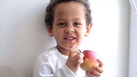 boy with apple just about to have a bite on white background stock video stock footage