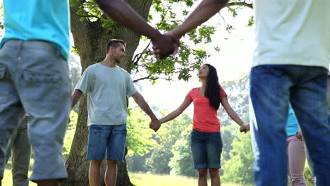 young people holding hands in a circle