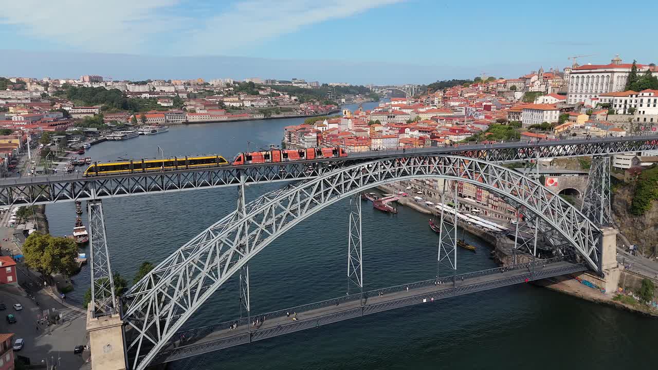 Aerial slow motion view of the train on the bridge in Porto, Portugal