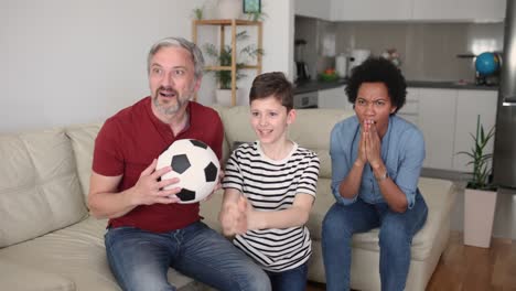excited family football fans watching sport tv game celebrating goal together