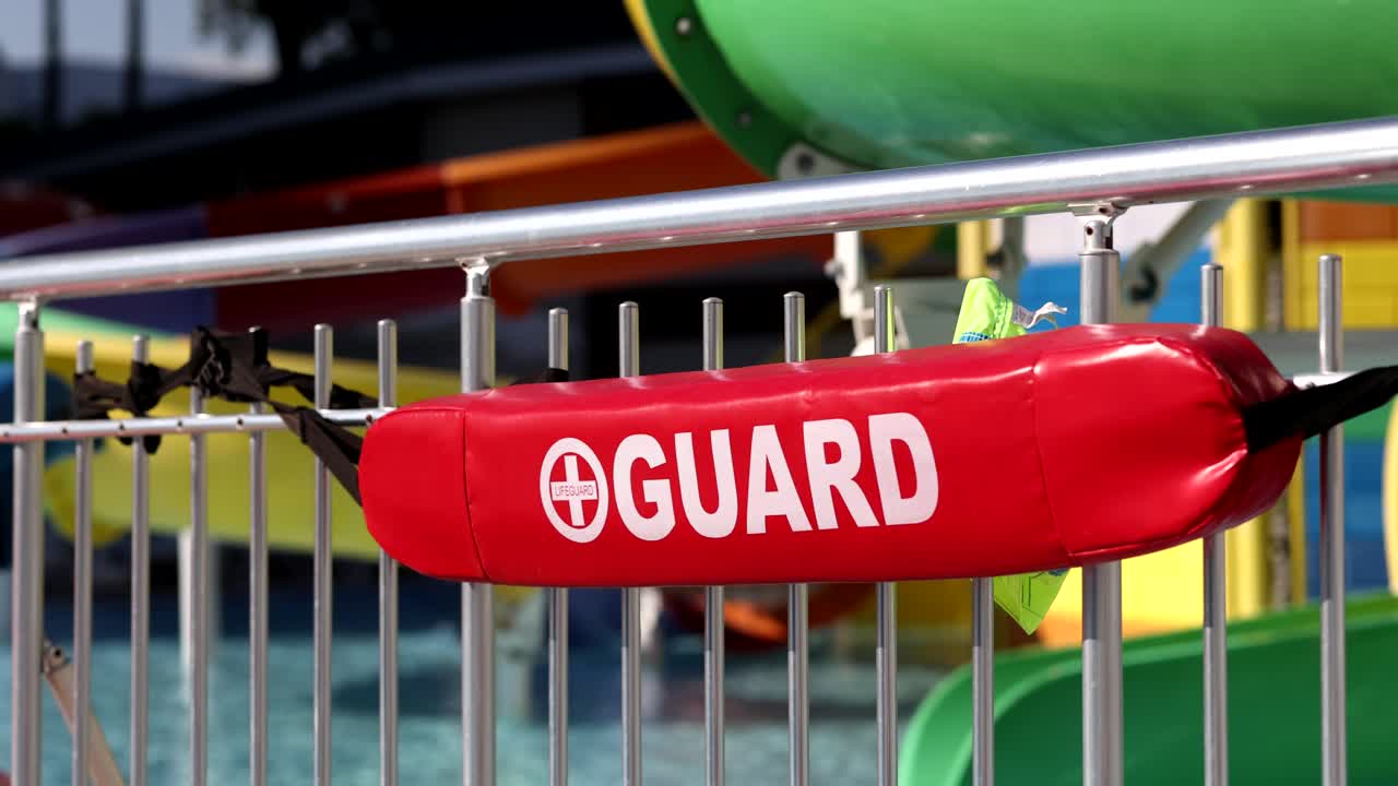 Lifeguard red sign by pool concept