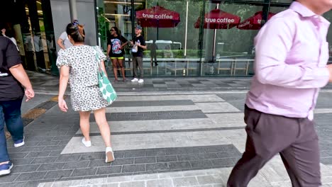 people walking towards a coffee shop entrance