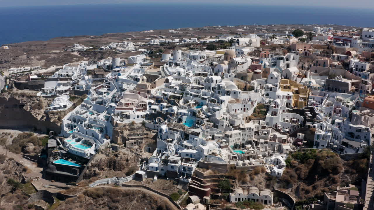icónico pueblo de oia en santorini, grecia durante el verano - toma aérea de drones