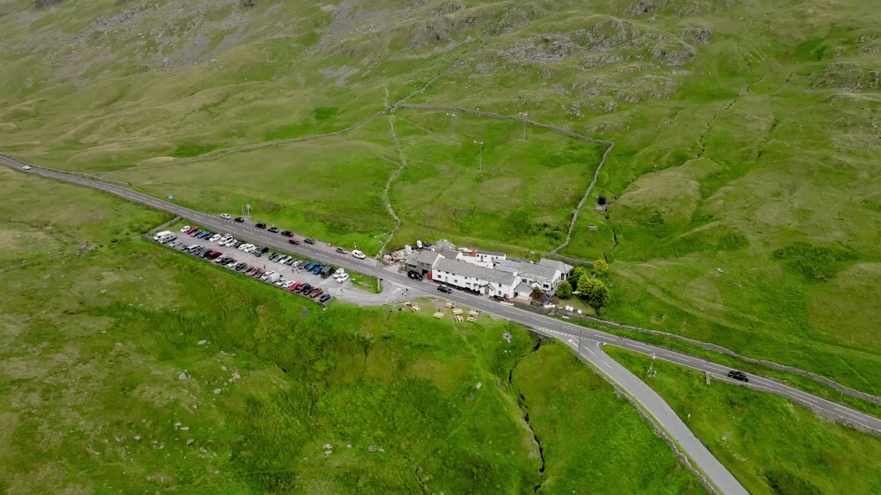 Summit of Kirkstone Pass With Inn And Busy Car Park. Lake District, Cumbria, UK