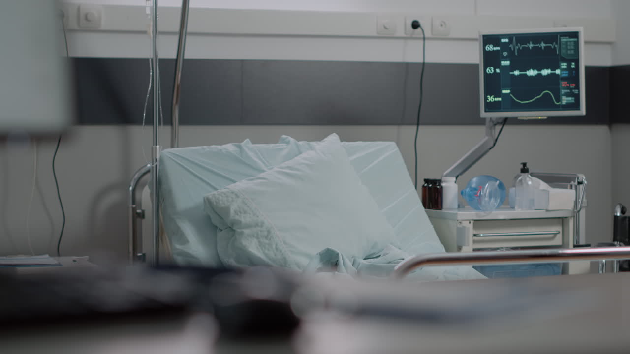 Woman working as nurse preparing bed in hospital ward