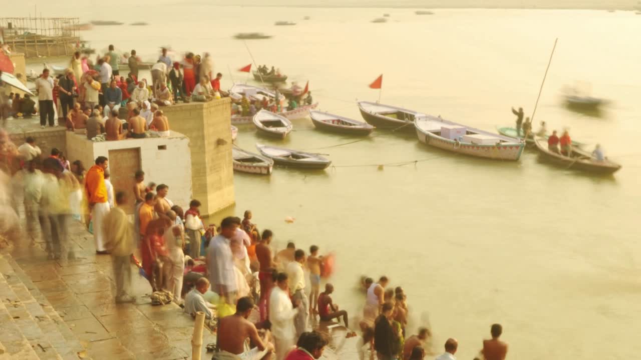 Time lapse Indian pilgrims rowing boat in sunrise. Ganges river at Varanasi India.