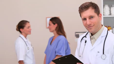 doctor writing on a clipboard