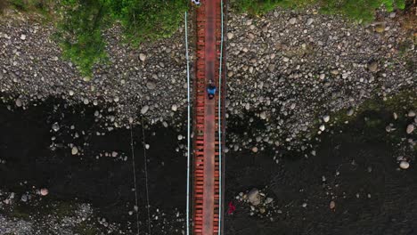 Bird's-Eye-View-Of-Hanging-Footbridge-In-Guinsaugon,-Southern-Leyte-In-The-Philippines---aerial-drone-shot