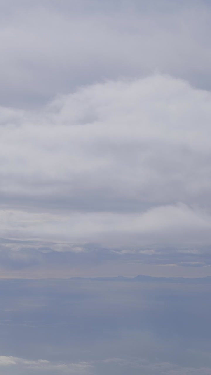 Tranquil cloudy sky over calm water reflecting a serene, peaceful mood